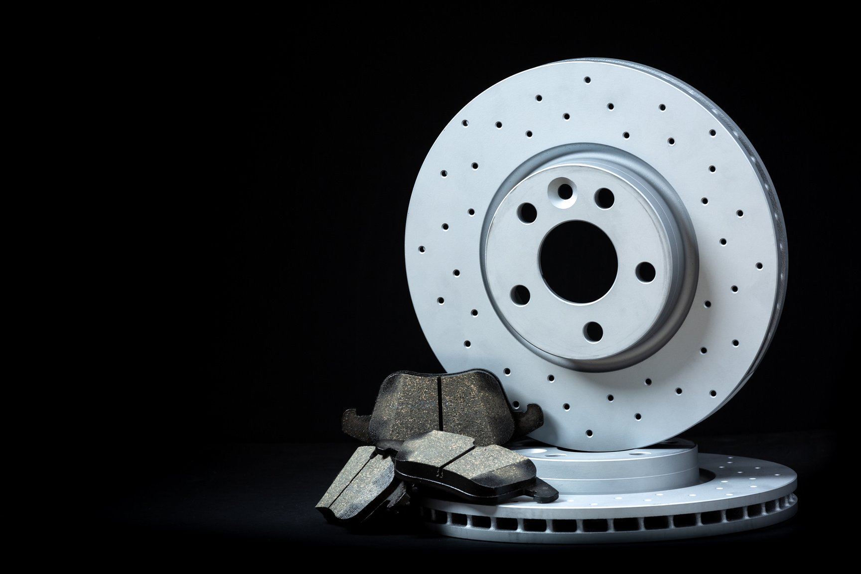 Set of sport brakes for the car. Brake discs with pads. Black background.