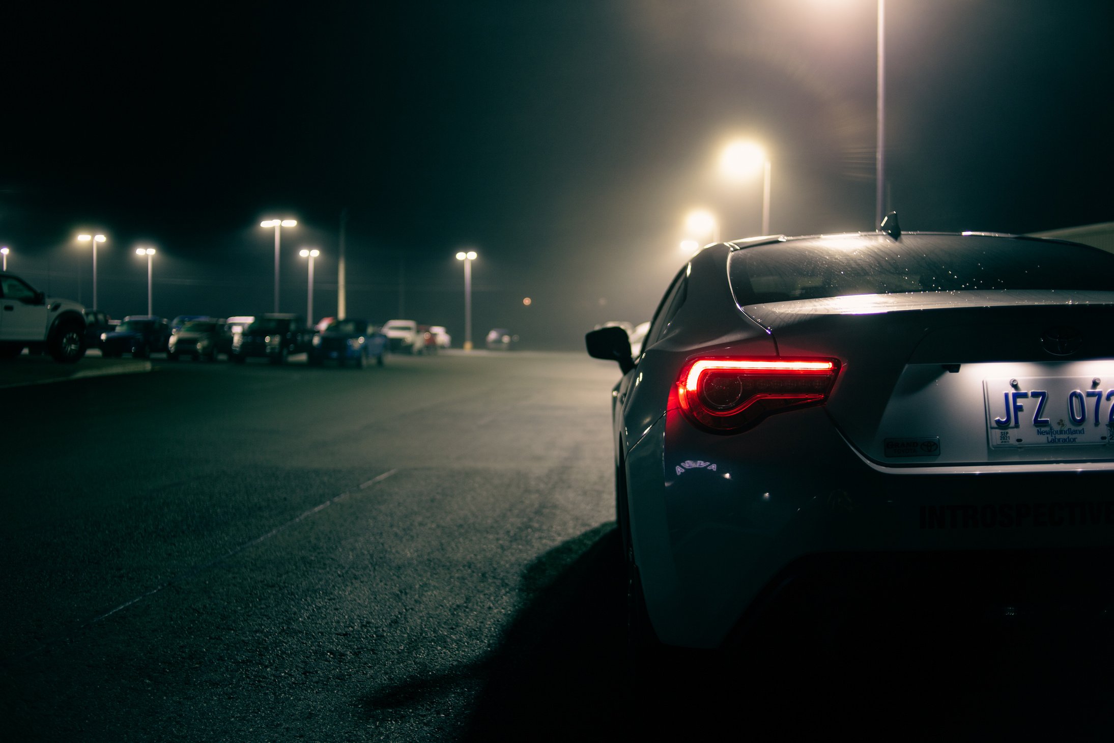 Sports car with luminous taillights on parking lot